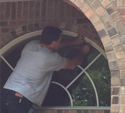 Man Repairing a Window